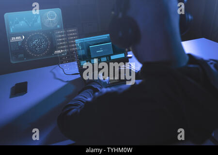hacker with progress bar on laptop in dark room Stock Photo