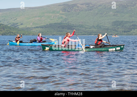 Luss, Loch Lomond, Scotland, UK. 26th June, 2019. UK weather - students from Hillpark Secondary School in Glasgow enjoying brilliant blue skies and bright sunshine this afternoon paddling on Loch Lomond for their Duke of Edinburgh silver expedition Credit: Kay Roxby/Alamy Live News Stock Photo