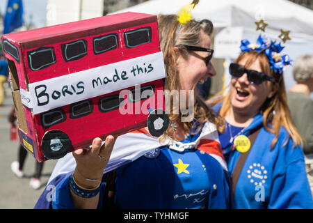London, UK. 26 June, 2019. A model of a ‘Boris Made This’ red bus at the 50th birthday celebration for noted anti-Brexit campaigner Steve Bray of SODEM (Stand of Defiance European Movement) outside Parliament. Yesterday, Conservative leadership candidate Boris Johnson stated during an interview on Talk Radio that he relaxes by crafting and painting model buses made from wooden crates. Credit: Mark Kerrison/Alamy Live News Stock Photo