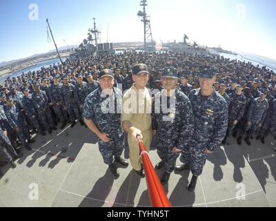 SAN DIEGO (Nov. 10, 2016) Master Chief Petty Officer of the Navy (MCPON) Steven Giordano takes a “selfie” with the command triad and crew of amphibious assault ship USS Boxer (LHD 4). MCPON Giordano held an all hands call to discuss the Navy's rating modernization efforts aboard. The rating modernization plan builds on the Sailor 2025 roadmap to better grow and utilize fleet talent. It will allow Sailors to experience a broader range of professional experiences and opportunities. Boxer is currently pier side preparing for a planned maintenance availability. Stock Photo