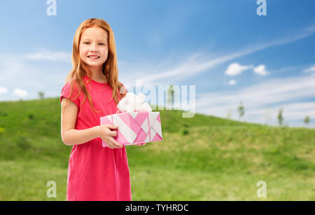 smiling red haired girl with birthday gift Stock Photo