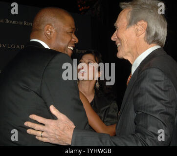 Actor-director Clint Eastwood whose movie 'Letters from Iwo Jima' won Best Film chats with actor Forest Whitaker (left) who won the Best Actor Award for his work in film 'The Last King of Scotland' at the 2006 National Board of Review Award ceremonies held in New York on January 9, 2007. Eastwood wife looks on.   (UPI Photo/Ezio Petersen) Stock Photo