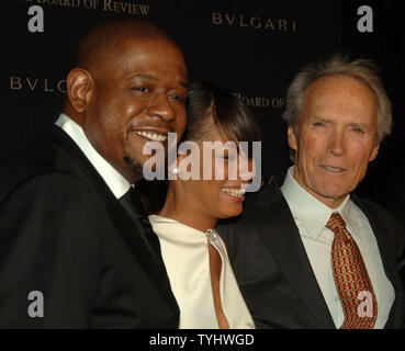 Actor-director Clint Eastwood whose movie 'Letters from Iwo Jima' won Best Film chats with actor Forest Whitaker (left) who won the Best Actor Award for his work in film 'The Last King of Scotland' at the 2006 National Board of Review Award ceremonies held in New York on January 9, 2007. Whitaker wife looks on.   (UPI Photo/Ezio Petersen) Stock Photo