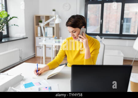 ui designer calling on smartphone at office Stock Photo