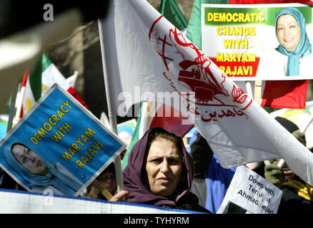 Robab Baraie of Washington, DC, holds a photo of  Maryam Rajavi, president of the National Council of Resistance of Iran, and the flag of the People's Mojahedin Organization of Iran as she takes part in a demonstration against Iran's president Mahmoud Ahmadinejad during a rally held near the United Nations on March 21, 2007 in New York City. Demonstrators, who oppose Iran's nuclear and human-rights policies, are calling for the UN to impose sanctions against Tehran.   (UPI Photo/Monika Graff) Stock Photo