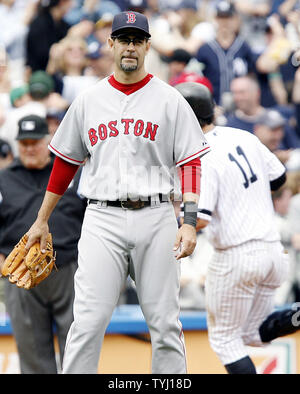 Boston Red Sox third baseman Mike Lowell reaches for an outside