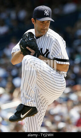 New York Yankees Mike Mussina follows through in the first inning of ...