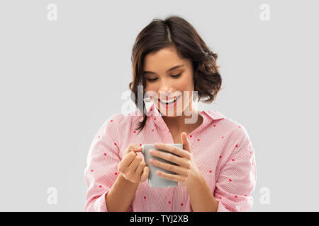 happy young woman in pajama with mug of coffee Stock Photo