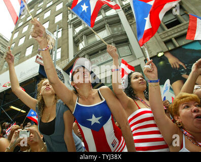 Crowds cheer as singer Ricky Martin passes by during the 50th National Puerto Rican Day parade which takes place along Fifth Avenue on June 10, 2007 in New York City. The annual event draws thousands of spectators and features dancers, marching bands and floats. (UPI Photo/Monika Graff) Stock Photo