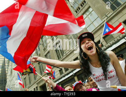 A woman joins the cheering crowds as singer ricky Martin passes during the 50th National Puerto Rican Day parade which takes place along Fifth Avenue on June 10, 2007 in New York City. The annual event draws thousands of spectators and features dancers, marching bands and floats. (UPI Photo/Monika Graff) Stock Photo