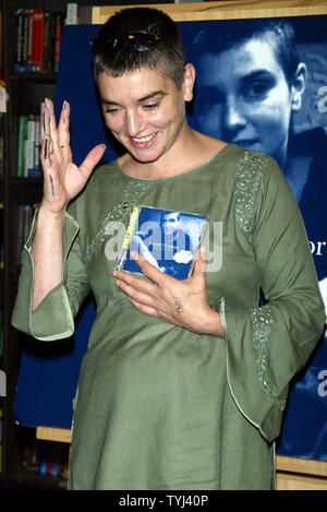 Sinead O'Connor poses for pictures before signing copies of her
