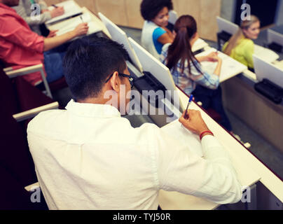 group of students with notebooks in lecture hall Stock Photo