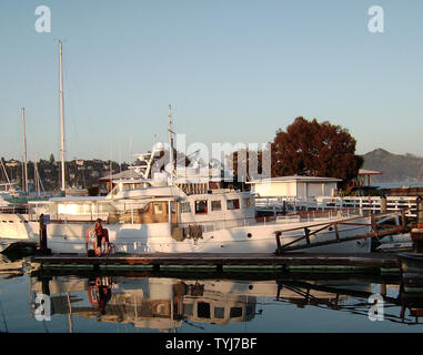 A houseboat is relatively affordable way of living in very expensive Sausalito, California. Note- the person is not recognizable. Stock Photo