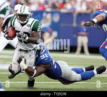 New York Jets Leon Washington (29) drags New York Giants Justin Tuck in the second quarter at Giants Stadium in East Rutherford, New Jersey on October 7, 2007. The New York Giants defeated the New York Jets 35-24.   (UPI Photo/John Angelillo) Stock Photo