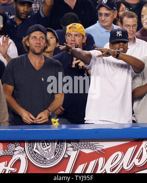 Jesse Itzler, Co-founder of Marquis Jet, and Jay-Z (R) smile and react  while the New York Yankees play the Cleveland Indians in game 4 of the ALDS  at Yankee Stadium in New