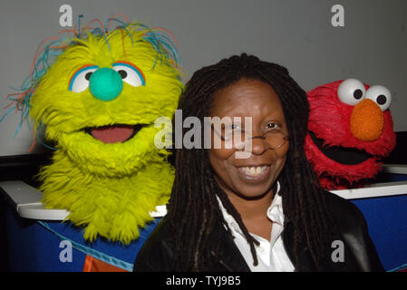 Actress Whoopi Goldberg poses with the new muppet Azibo (L) and Elmo (R) after a news conference to announce 'Panwapa', a new world wide initiative from Sesame Street Workshop to cultivate the next generation of globally responsible children, at the United Nations International School in New York on October 10, 2007.  (UPI Photo/Ezio Petersen) Stock Photo