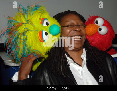 Actress Whoopi Goldberg poses with the new muppet Azibo (L) and Elmo (R) after a news conference to announce 'Panwapa', a new world wide initiative from Sesame Street Workshop to cultivate the next generation of globally responsible children, at the United Nations International School in New York on October 10, 2007. (UPI Photo/Ezio Petersen) Stock Photo