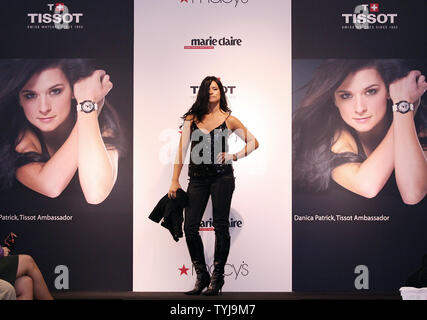 Danica Patrick shows off a Tissot watch on the runway during a