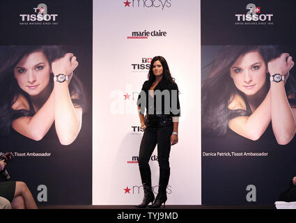 Danica Patrick shows off a Tissot watch on the runway during a