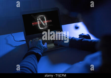 hands of hacker with access denied message laptop Stock Photo