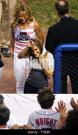 Sarah Jessica Parker waves to fans while walking into the dug out with Sheryl Crow behind her at the 79th All Star Game at Yankee Stadium in New York City on July 15, 2008.        (UPI Photo/John Angelillo) Stock Photo