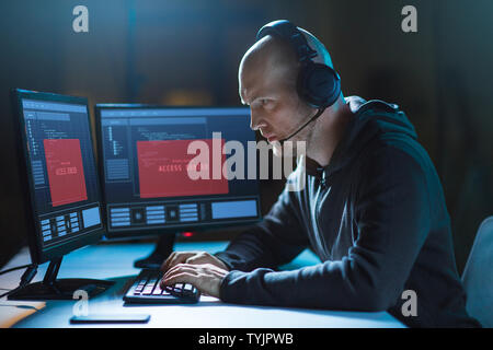 hacker with access denied messages on computers Stock Photo