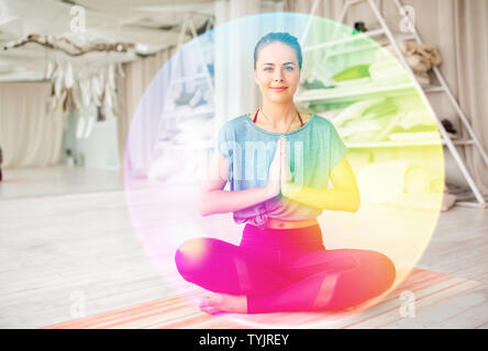 woman meditating in lotus pose at yoga studio Stock Photo