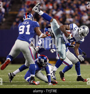 Dallas Cowboys Martellus Bennett (80) goes sideways near New York Giants  Justin Tuck in the third quarter at Giants Stadium in East Rutherford, New  Jersey on November 2, 2008. The Giants defeated