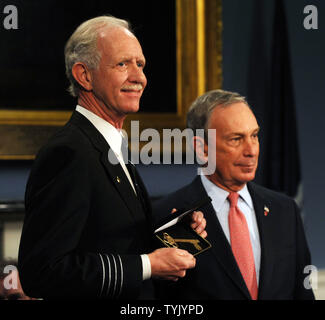 Mayor Michael Bloomberg (r) presents Captain Chesley Sullenberger and the flight crew of US Airways Flight 1549 with keys to the city during City Hall ceremonies in New York on February 9, 2009.   (UPI Photo/Ezio Petersen) Stock Photo