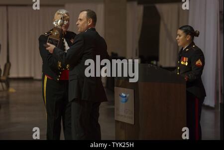 Retired U.S. Marine Corps Sgt. Maj. Scott L. Theakston (right), accepts an award from Lt. Col. John C. Golden, commanding officer, Headquarters Battalion, for being the guest of honor at the Headquarters Battalion, 2d Marine Division 241st Birthday Ball, Wilmington Convention Center, Wilmington, N.C., Nov. 12, 2016. The Marine Corps has carried 241 years of traditions, values and standards since its establishment in 1775. Stock Photo