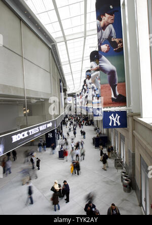 Yankees fans walk through the Yankees Museum before the New York Yankees  play the Cleveland Indians in the first regular season game at the new Yankee  Stadium in New York City on