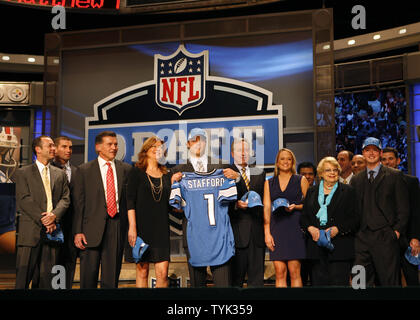 Georgia quarterback Matthew Stafford holds up his Detroit Lions