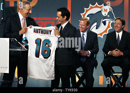 Marc Anthony and Stephen Ross hold a Miami Dolphins Jersey on the