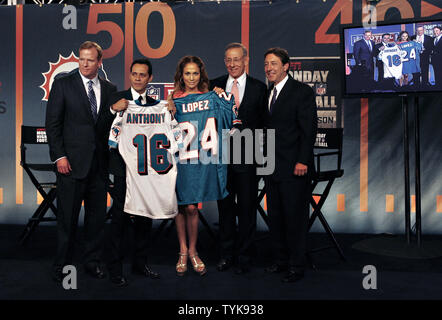 Marc Anthony and Stephen Ross hold a Miami Dolphins Jersey on the