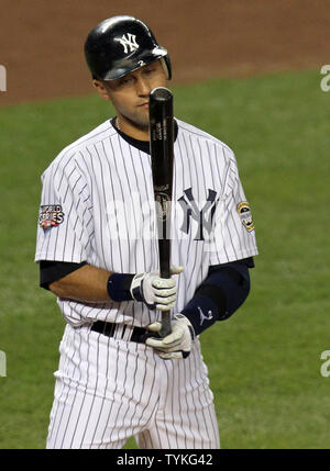 New York Yankees Derek Jeter looks at his bat before stepping into the box  in the first inning against the Philadelphia Phillies in game 2 of the World  Series at Yankee Stadium