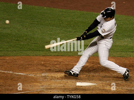 New York Yankees' Hideki Matsui, #55, is congratulated by team mates after  hitting a two-run homer off of the Philadelphia Phillies in which Alex  Rodriguez (L) scores in the second inning of