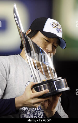 2009 World Series MVP Hideki Matsui, center, who wore the number 55 as a  member of the New York Yankees, is flanked by his father Masao, left, and  mother Saeko, as he