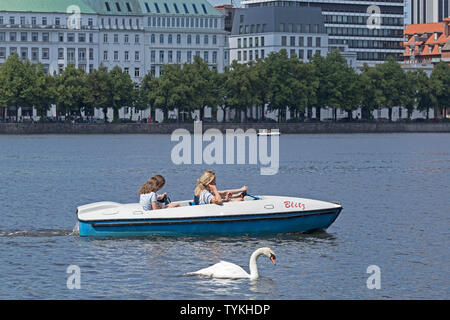 pedal boat on lake Inner Alster with the street Neuer Jungfernstieg in the background , Hamburg, Germany Stock Photo