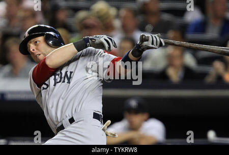 The Boston Red Sox's Shane Victorino (18) tosses his helmet after