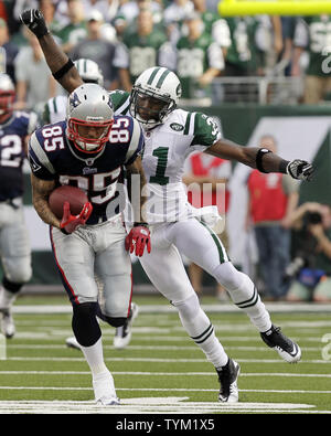 New England Patriots' Aaron Hernandez (81) is tackled by New York Jets'  Kyle Wilson (20) and Jim Leonhard (36) during the third quarter of an NFL  football game Sunday, Nov. 13, 2011