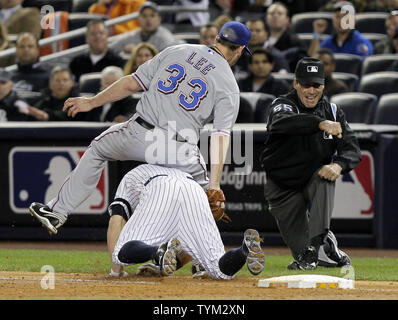 First base umpire Angel Hernandez, right, makes the out call as Texas  Rangers starting pitcher Cliff Lee (33) falls over New York Yankees' Brett  Gardner for an out to end the third