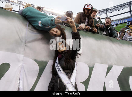 Miss Universe Ximena Navarrete takes a photo with a fan before the New York Jets play the Miami Dolphins in week 14 of the NFL season at New Meadowlands Stadium in East Rutherford, New Jersey on December 12, 2010. The Dolphins defeated the Jets 10-6.    UPI /John Angelillo Stock Photo