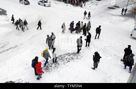 Pedestrians walk through Times Square after a blizzard hit the northeastern United States dumping in some places up to 29 inches of snow in New York City on December 27, 2010.    UPI/John Angelillo Stock Photo