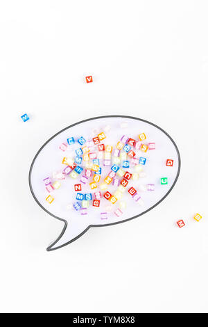 Creative flat lay back to school education concept with speech bubble lightbox and multicolor letters isolated on white background with copy space, te Stock Photo