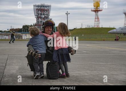 NAVAL AIR FACILITY ATSUGI, Japan (Nov. 16, 2016) Lt. Cmdr. Scott Stratman, from Mentor, Ohio, a pilot assigned to the Diamondbacks of Strike Fighter Squadron (VFA) 102, from Dallas, is greeted by his children on the flight line upon departing his aircraft. The Diamondbacks, along with other squadrons from Carrier Air Wing 5, returned to their forward operating base at Naval Air Facility Atsugi upon the completion of a patrol with the Navy’s only forward-deployed aircraft carrier USS Ronald Reagan (CVN 76). Stock Photo