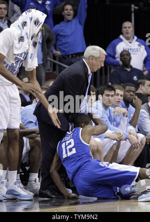 The Kentucky Wildcats Brandon Knight crashes into North Carolina Tar Heels head coach Roy Williams in the second half at the NCAA East Regional Round of 8 game at the Prudential Center in Newark, New Jersey on March 27, 2011. Kentucky defeated North Carolina 76-69 and advance to the NCAA Final Four.  UPI/John Angelillo Stock Photo