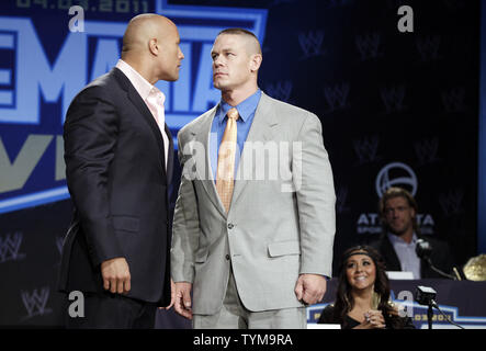 Nicole 'Snooki' Polizzi, watches Wrestler Dwayne 'The Rock' Johnson  Wrestler John Cena (R) stand on the stage at the WrestleMania XXVII Press Conference at The Hard Rock Cafe in New York City on March 30, 2011.       UPI/John Angelillo Stock Photo