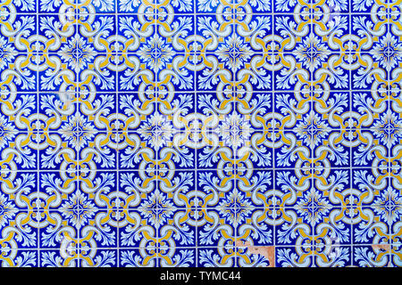 Repeated pattern of traditional Portuguese azulejo tiles - blue, yellow and white (close-up, frontal parallel view)