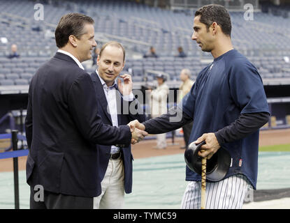 New York Yankees GM Brian Cashman watches Jorge Posada shake hands with NCAA Kentucky head coach John Calipari before the game against the Boston Red Sox at Yankee Stadium in New York City on May 15, 2011.   UPI/John Angelillo Stock Photo