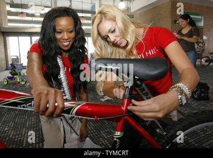 Miss USA contestants Amber-Joi Watkins (L) of Pennsylvania and Sarah Chapman of Nevada work together during the USO Build a Bike event where bikes are assemble and donated to military families at Pier 88 on May 26, 2011 in New York City.    UPI /Monika Graff. Stock Photo